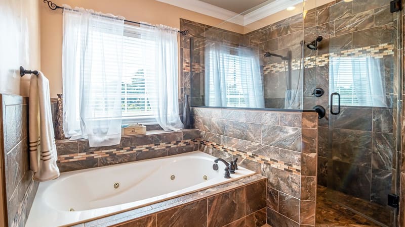A bright bathroom with a walk-in shower and a bathtub